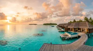 Overwater villas on a turquoise lagoon at sunset